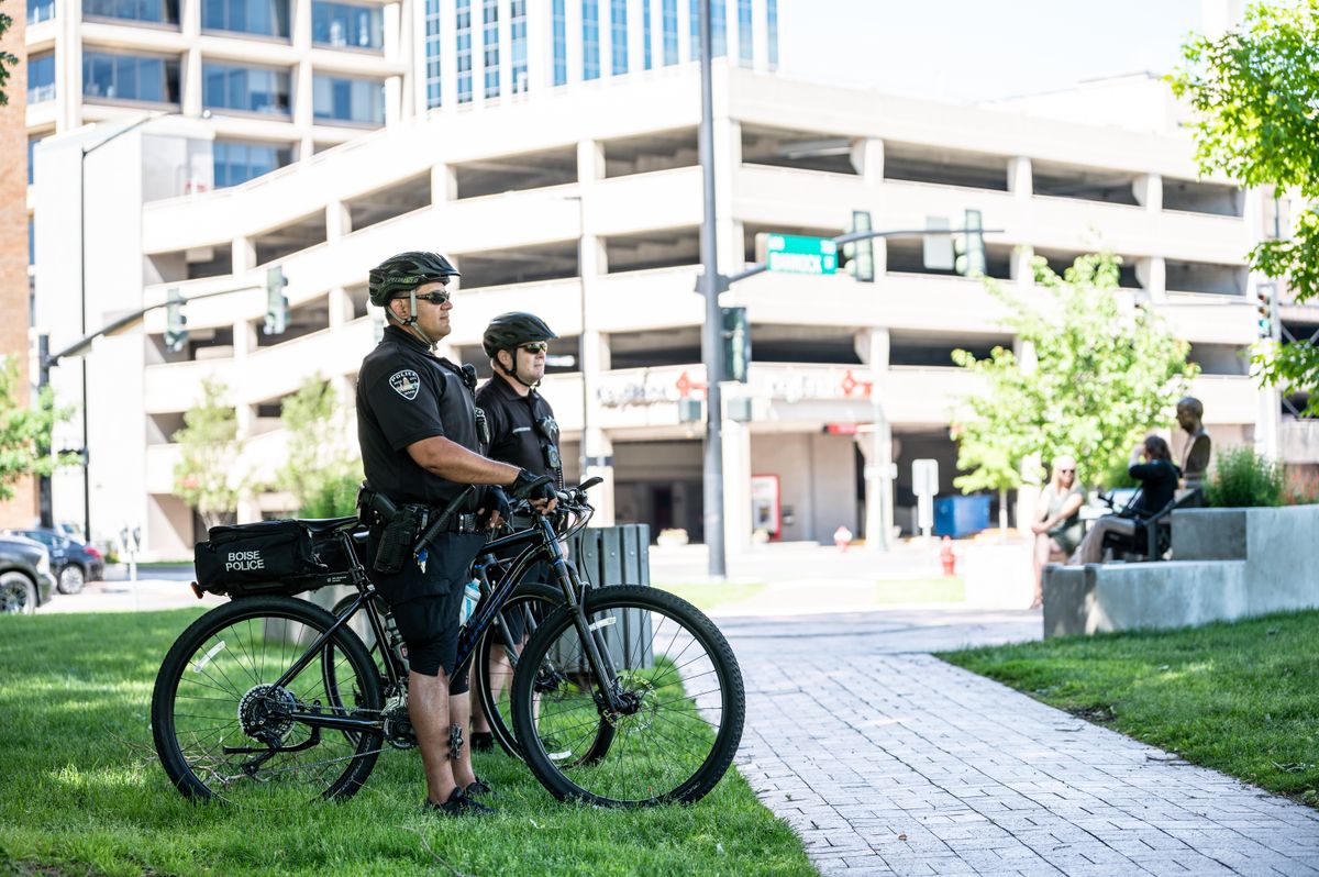 Uniformed bike patrol security officer riding through an Orlando apartment community